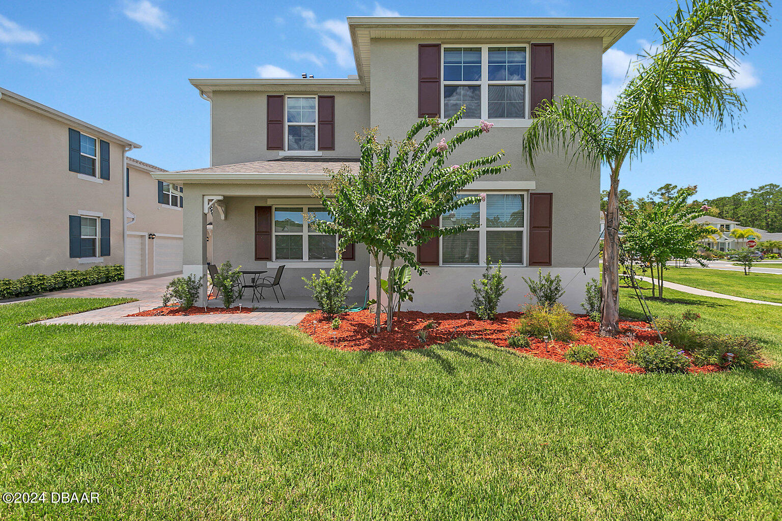 a front view of house with yard and outdoor seating