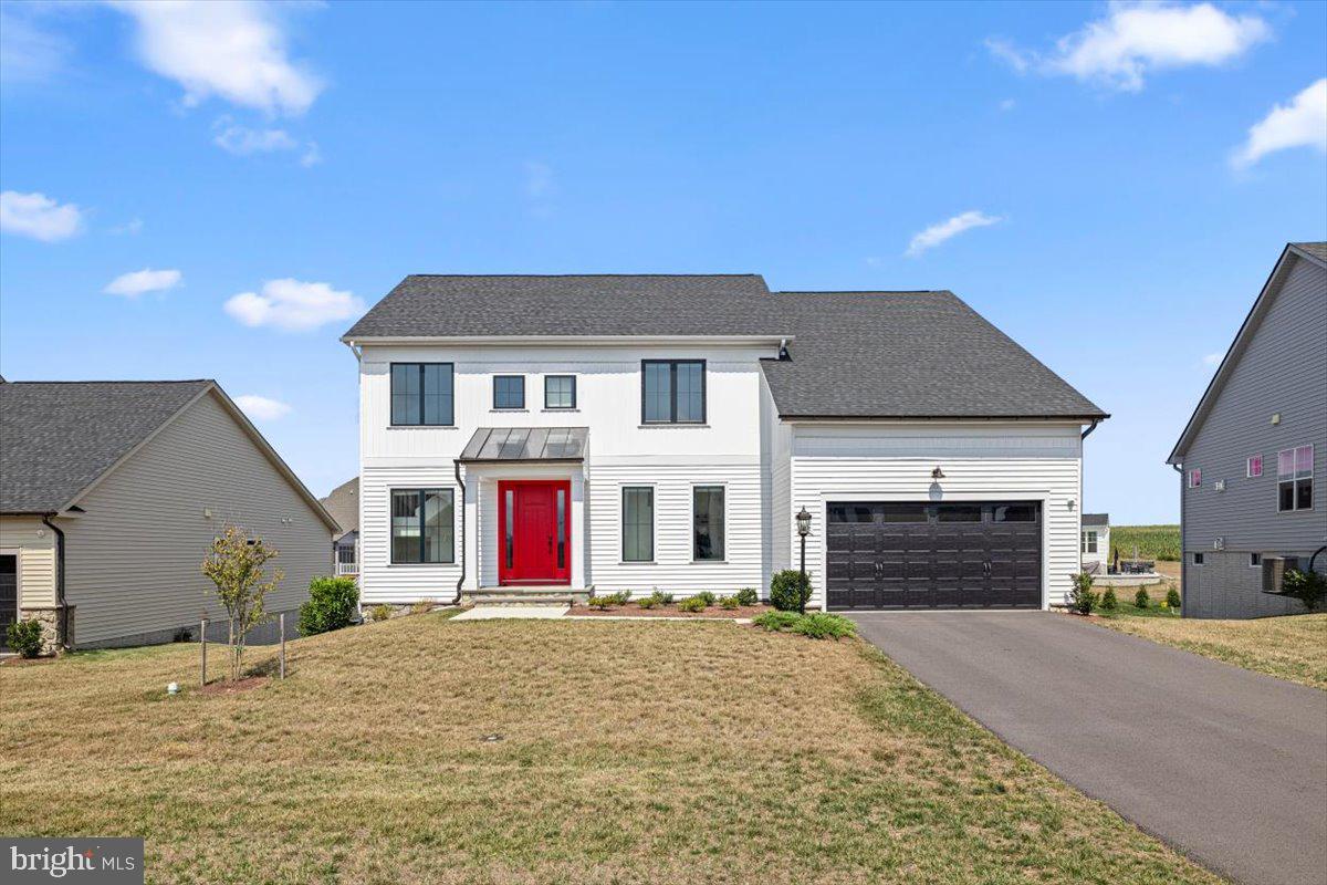 a front view of a house with yard and road