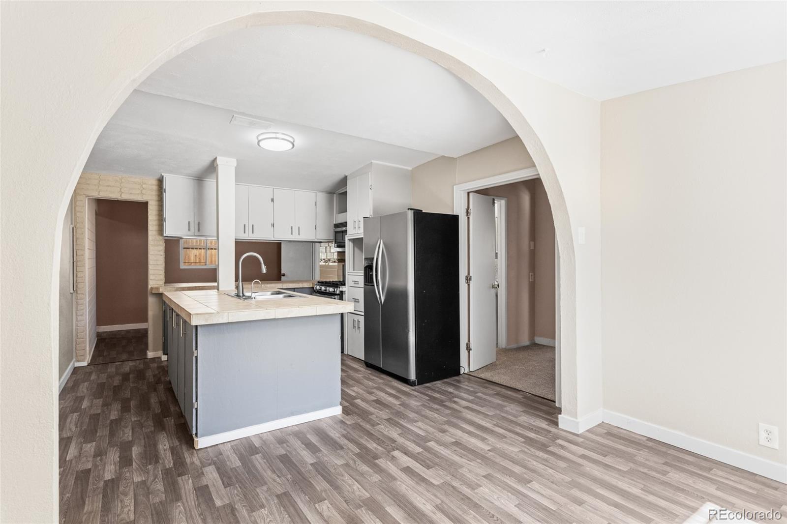 a kitchen with stainless steel appliances a refrigerator and a stove top oven