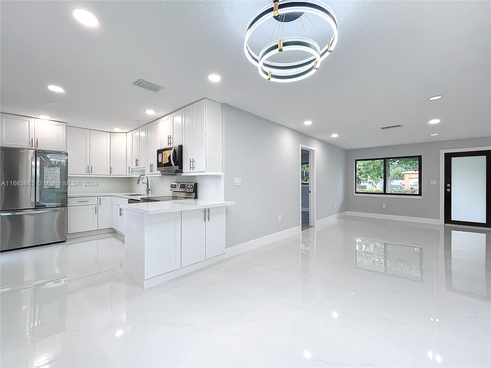 a kitchen with a refrigerator and microwave