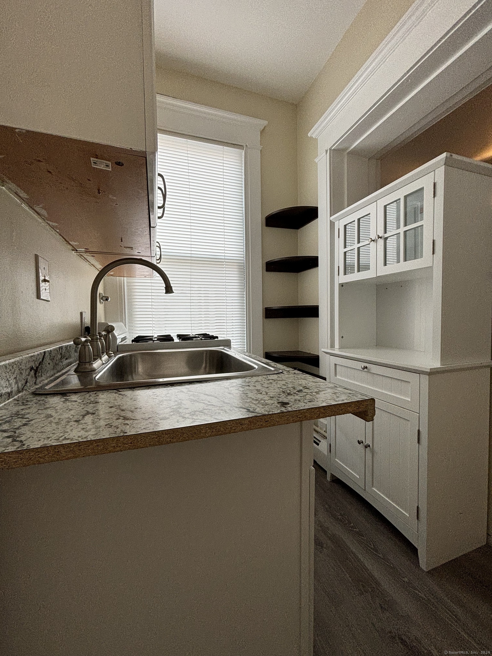 a kitchen with stainless steel appliances granite countertop a sink and a stove