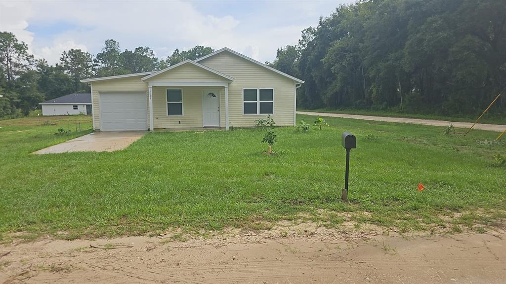 a view of a house with a backyard