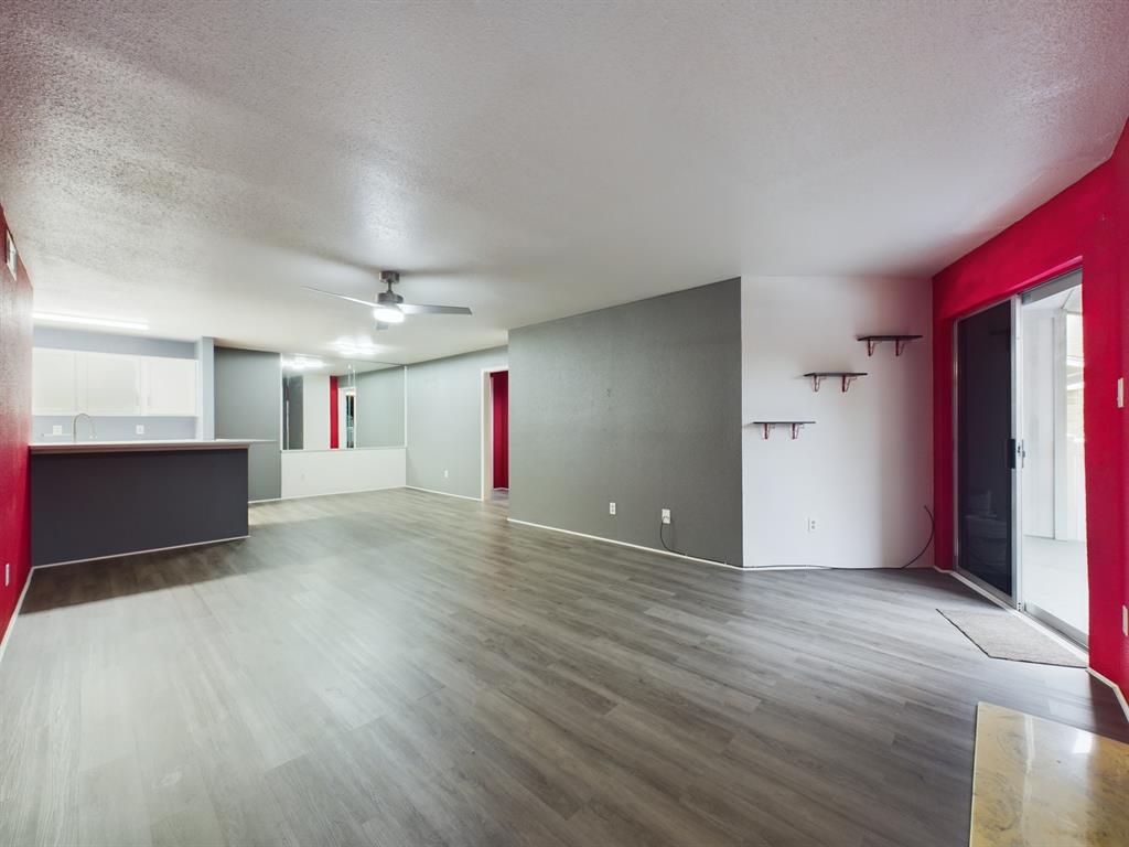 a view of a room with wooden floor and window