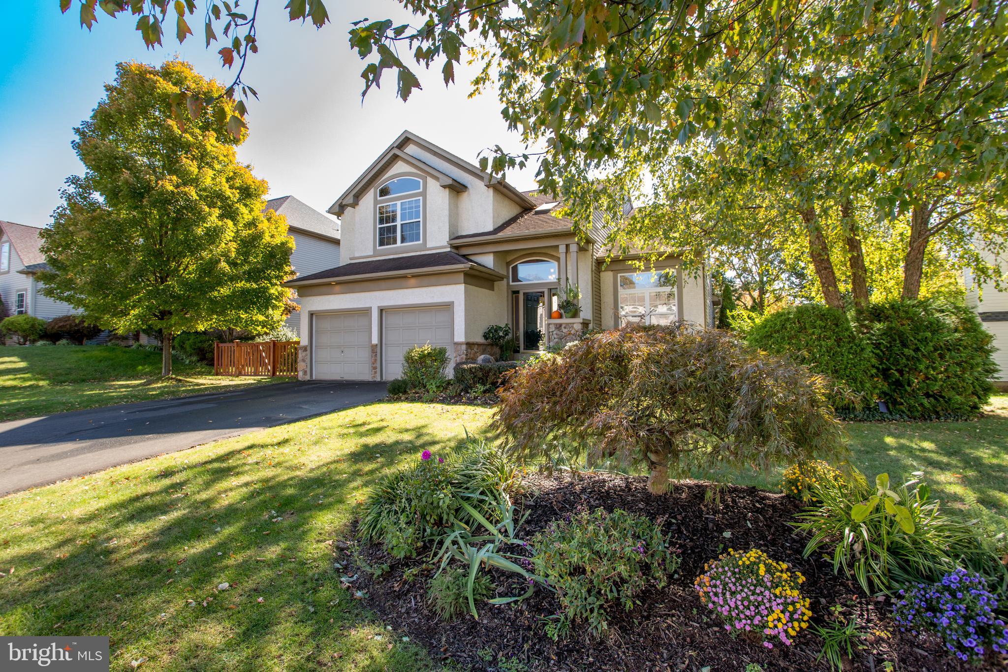 a front view of a house with a yard and shrubs