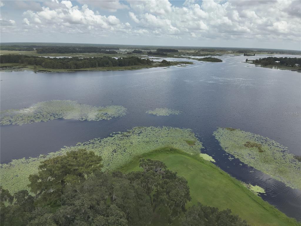 a view of a lake with a yard