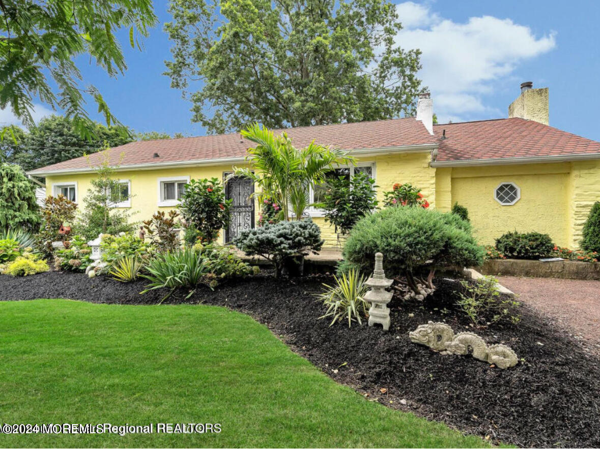 a view of a house with a yard and garden