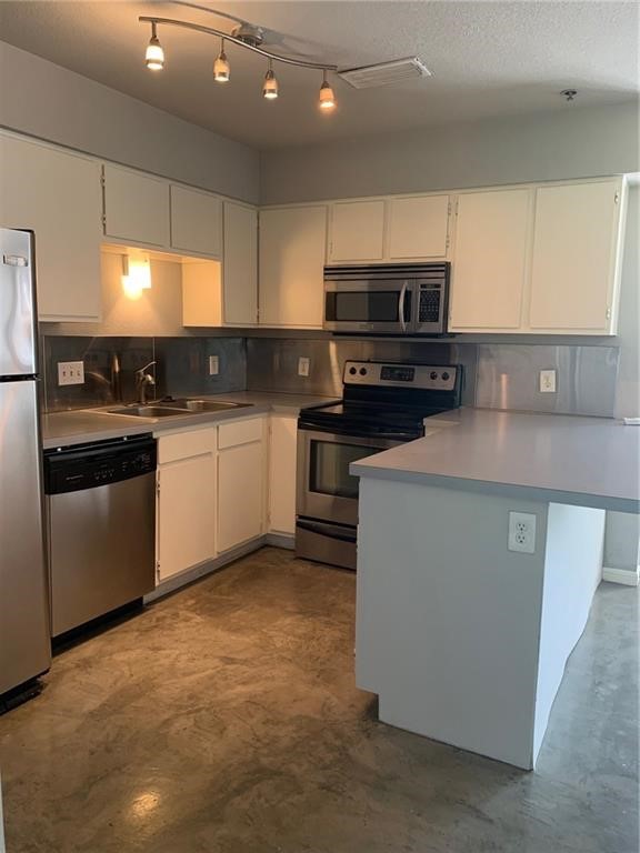 a kitchen with stainless steel appliances and a sink