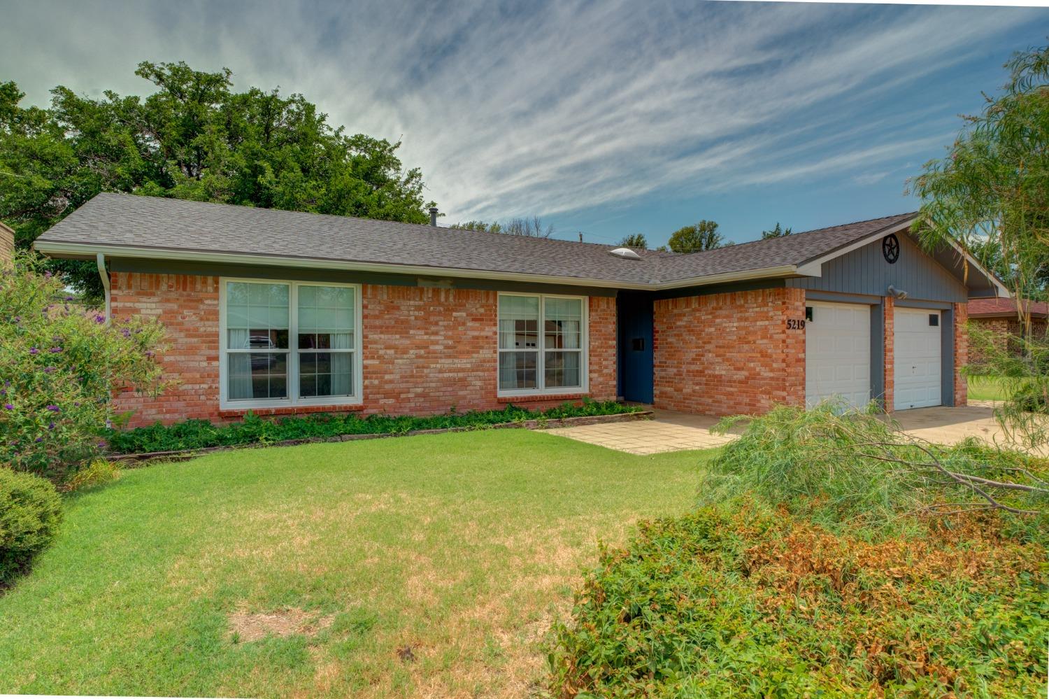 front view of a house with a yard