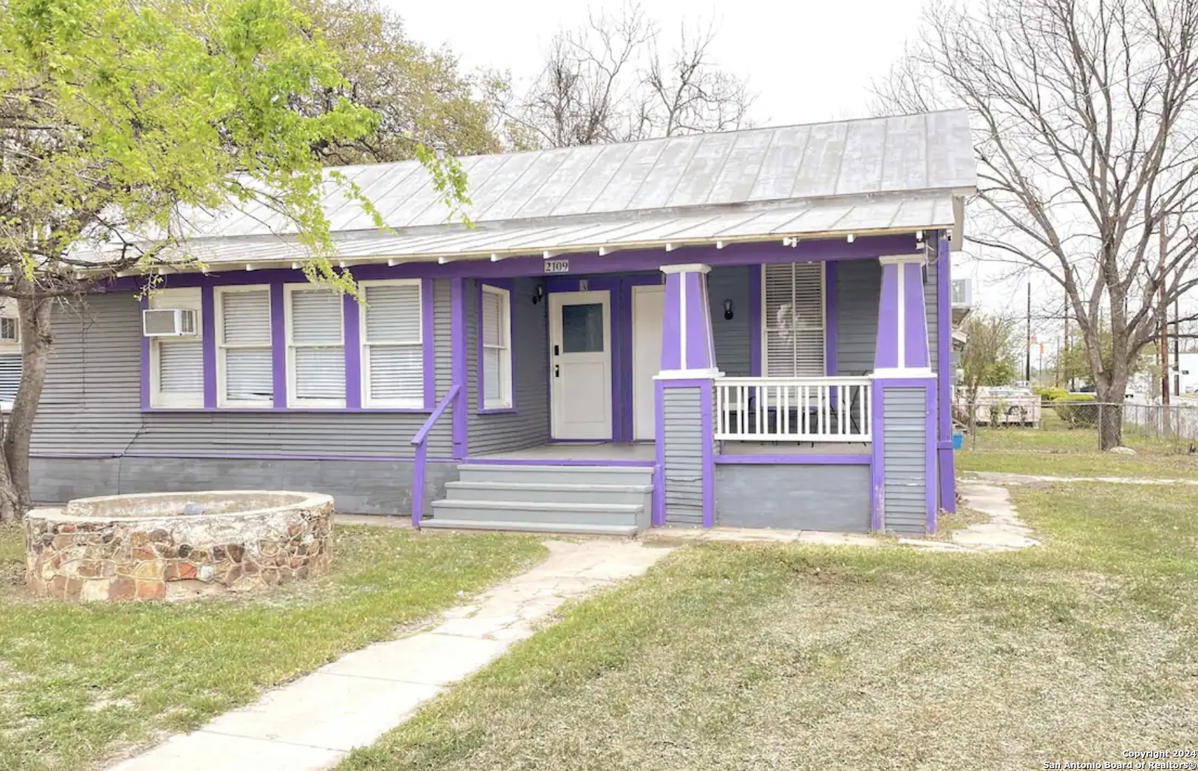 a front view of a house with a yard table and chairs