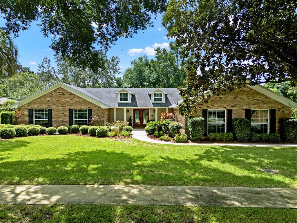 a front view of a house with yard porch and green space