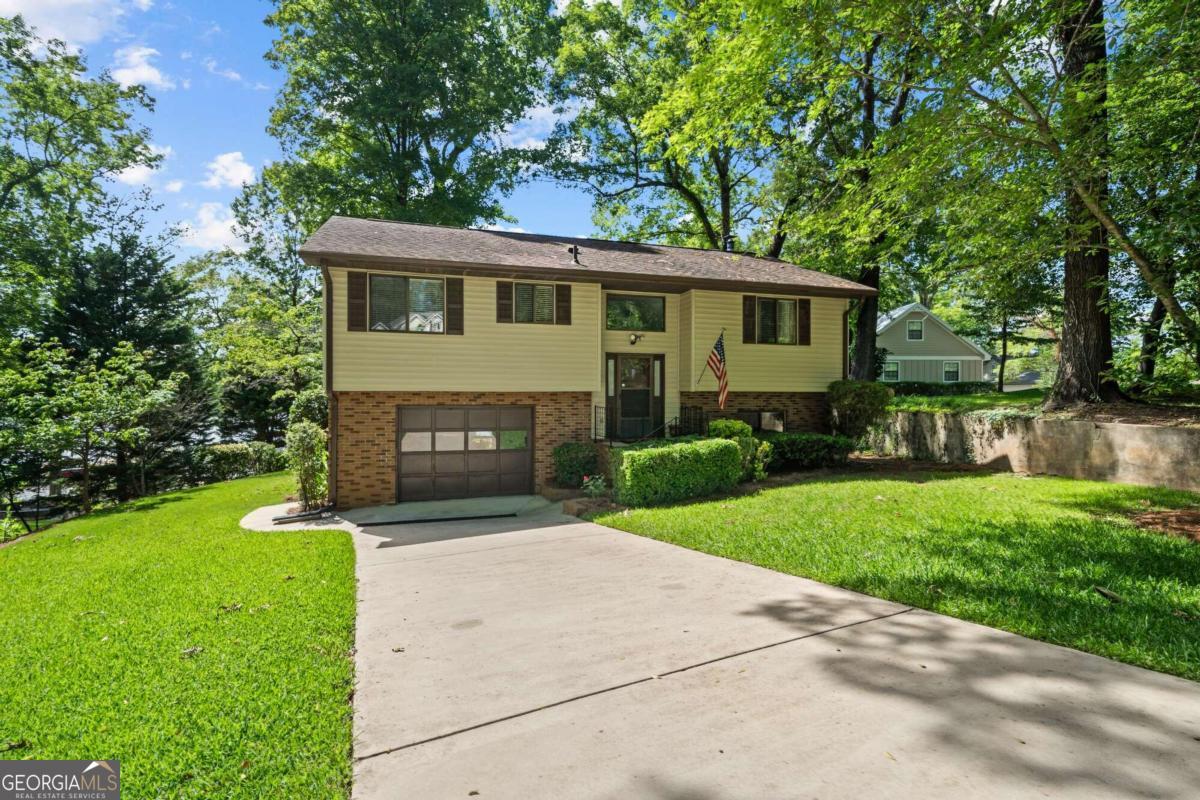 a front view of a house with a garden and yard