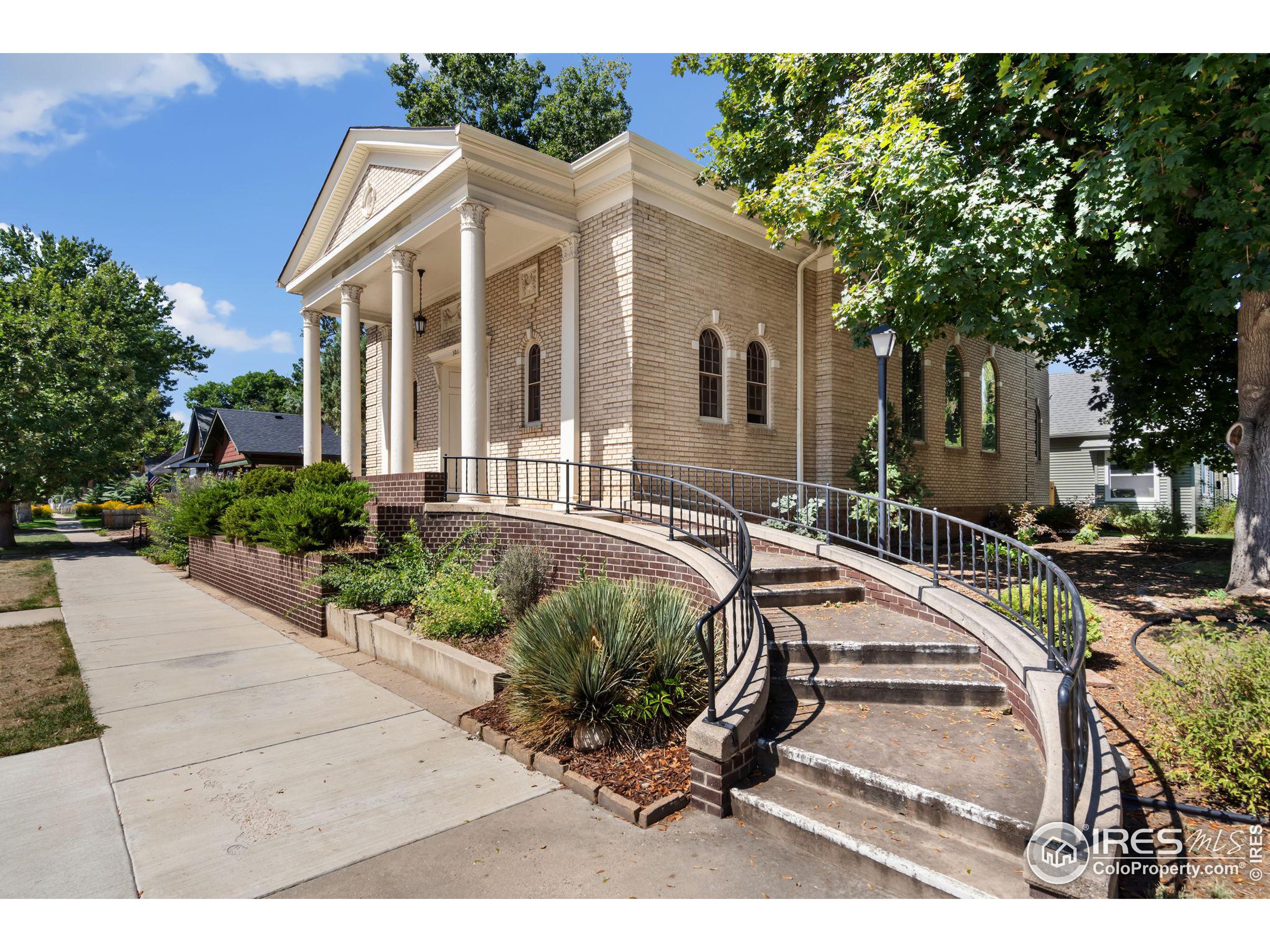 a view of a white house with a yard patio and sitting area