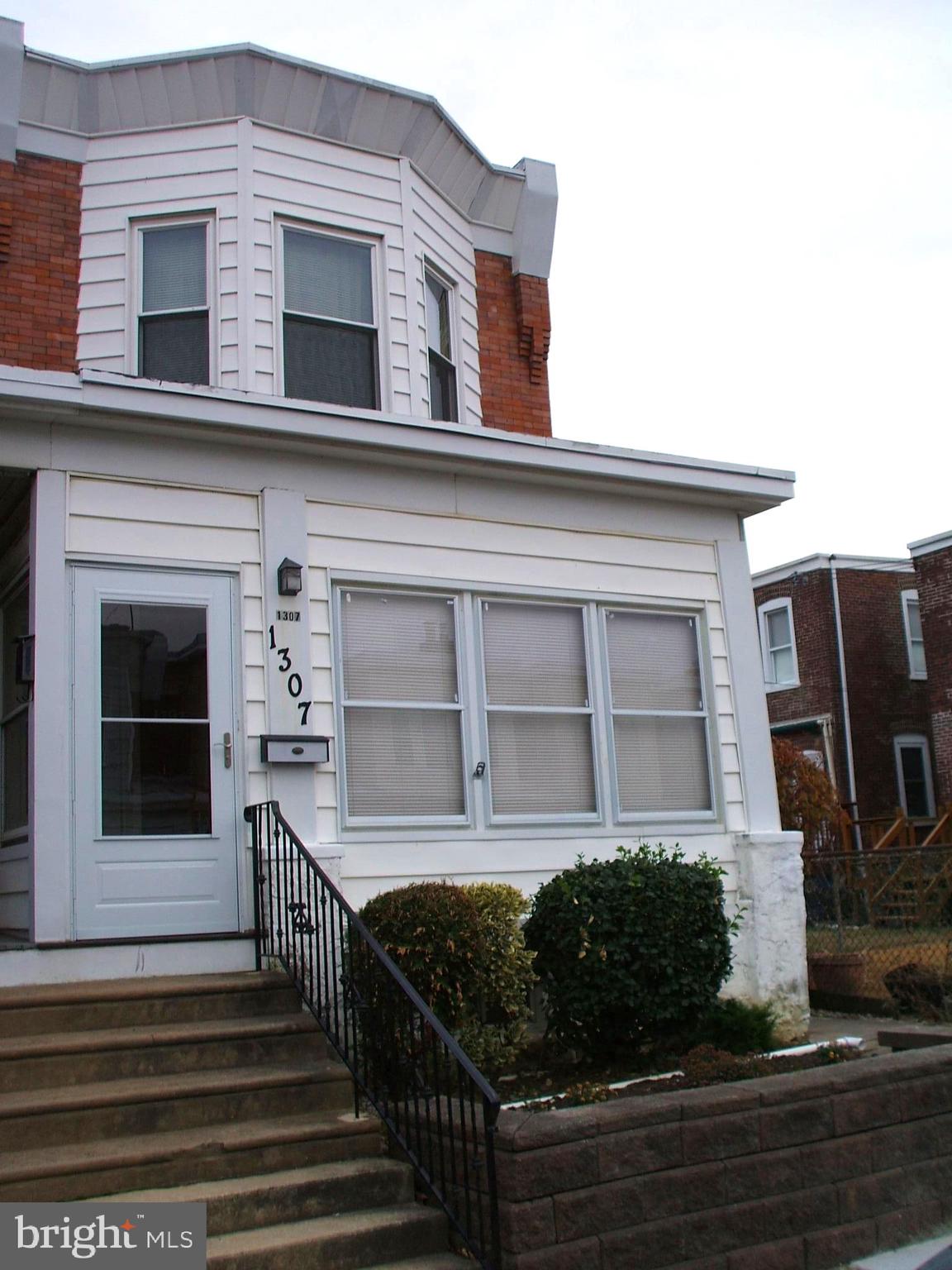 a view of a house with more windows and brick walls