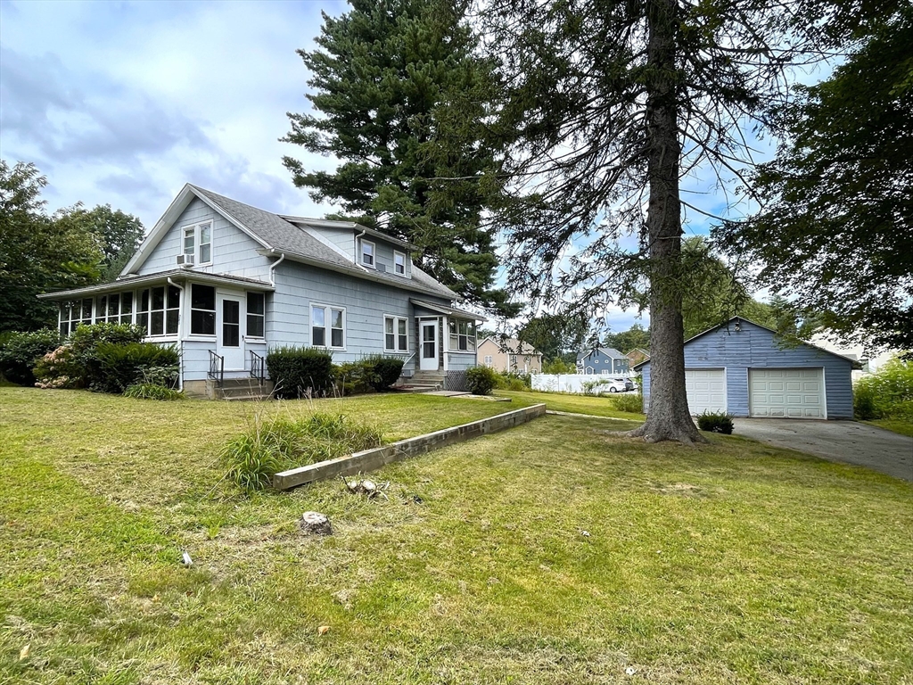 a front view of a house with a yard table and chairs