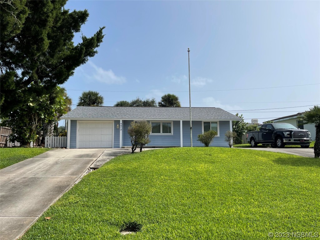 a front view of a house with a garden and yard