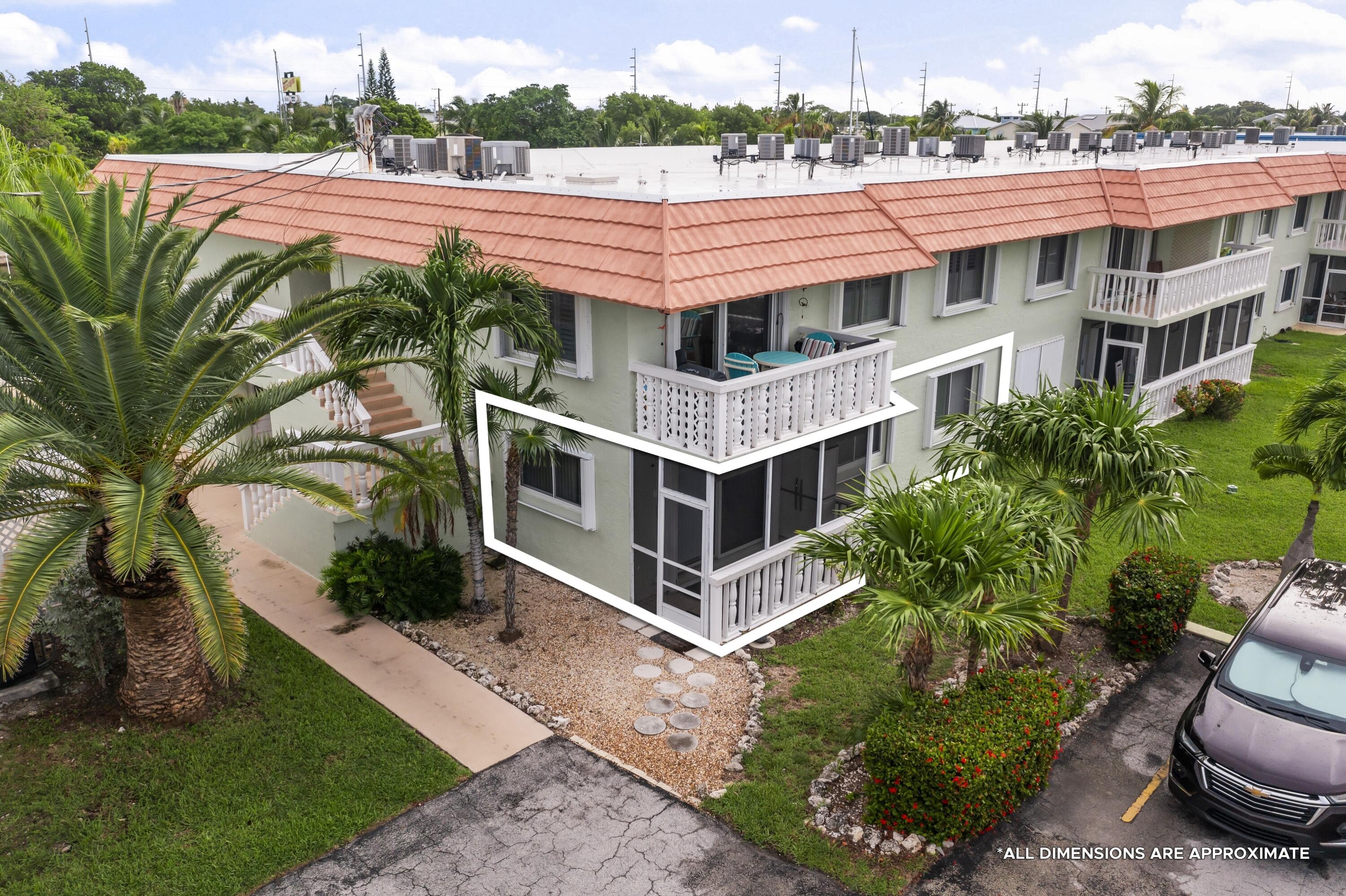 a aerial view of a house with a yard in front of it