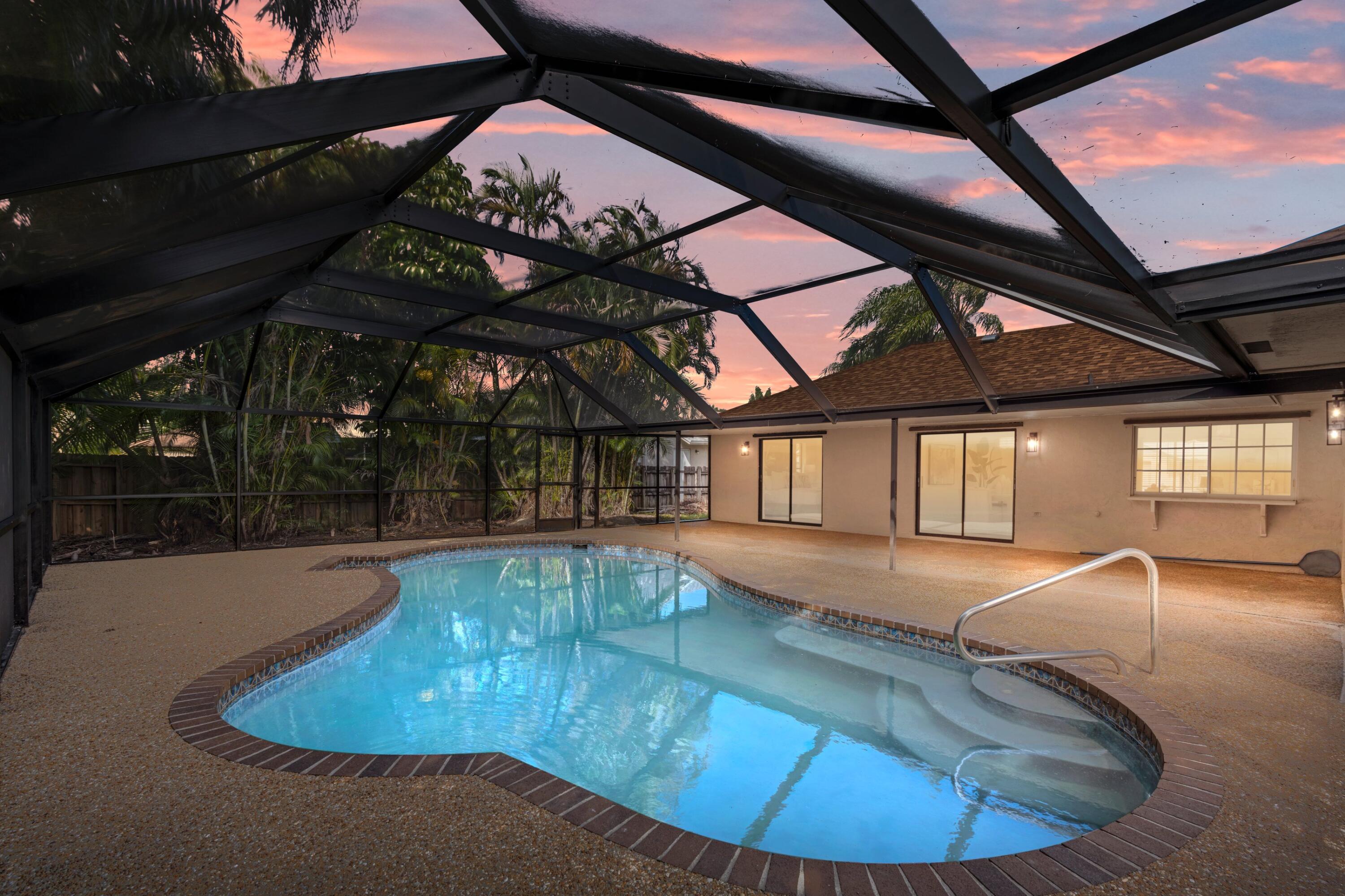 a view of a swimming pool with a yard