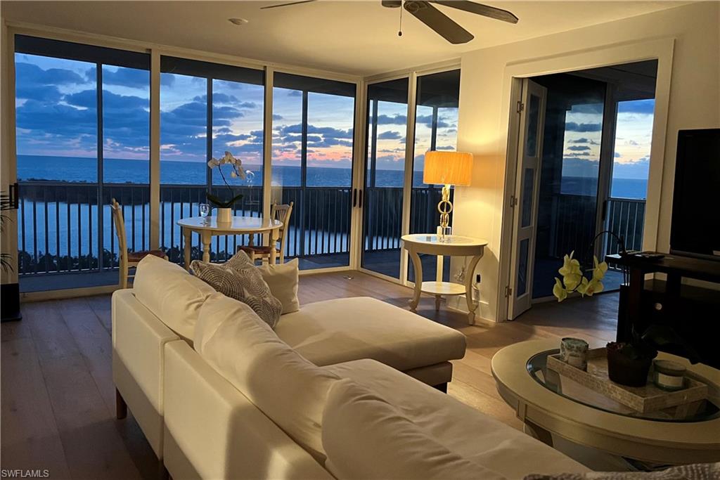 a living room with furniture and a floor to ceiling window