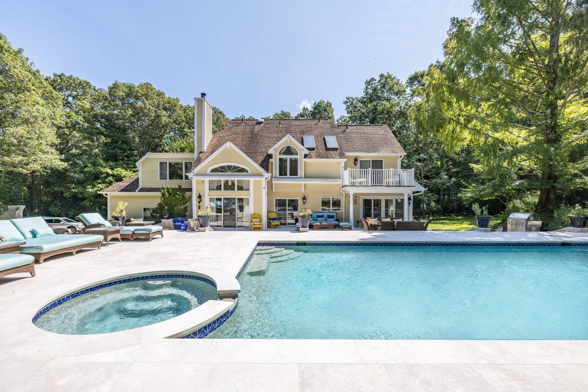 a swimming pool with outdoor seating and yard