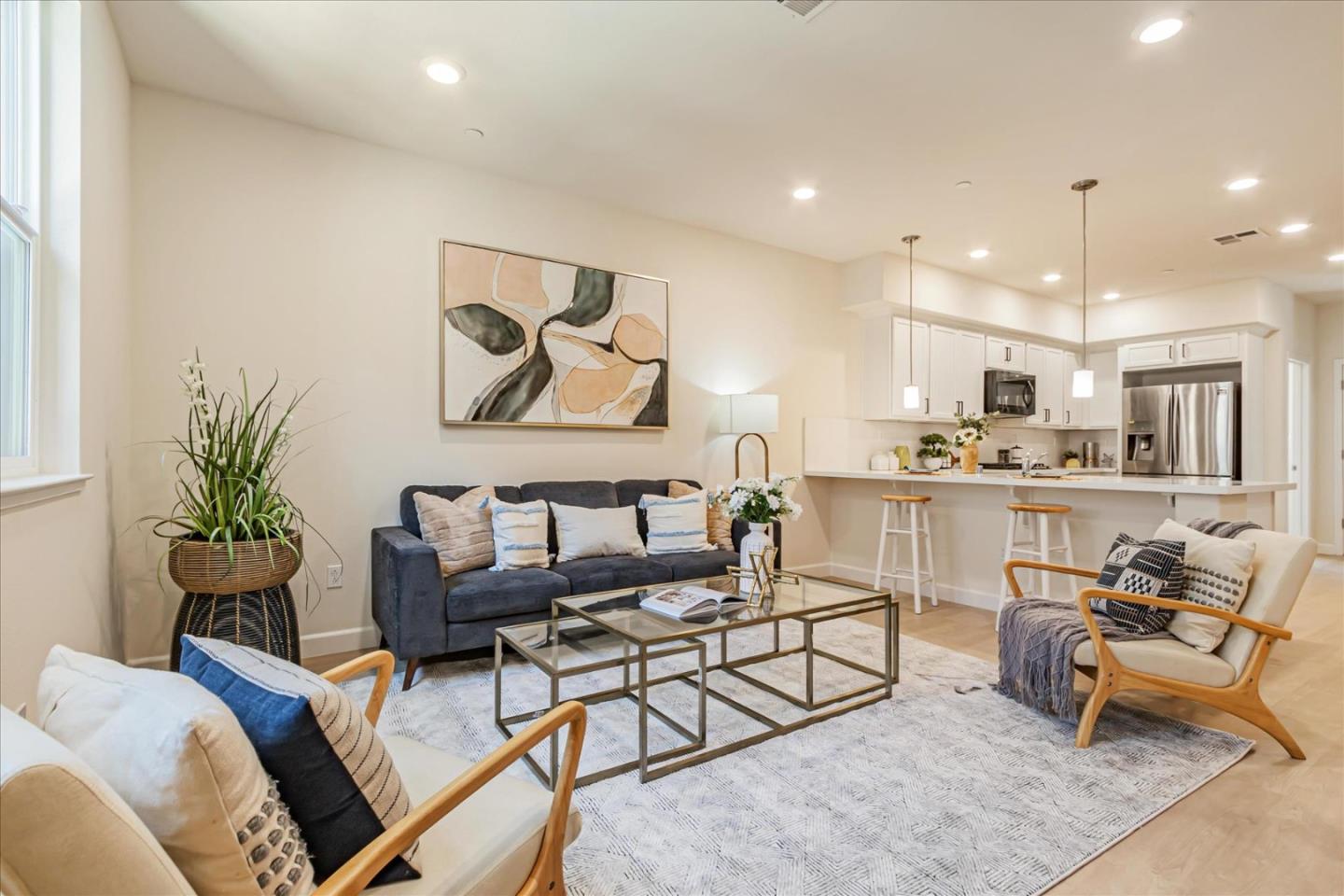 a living room with furniture and kitchen view