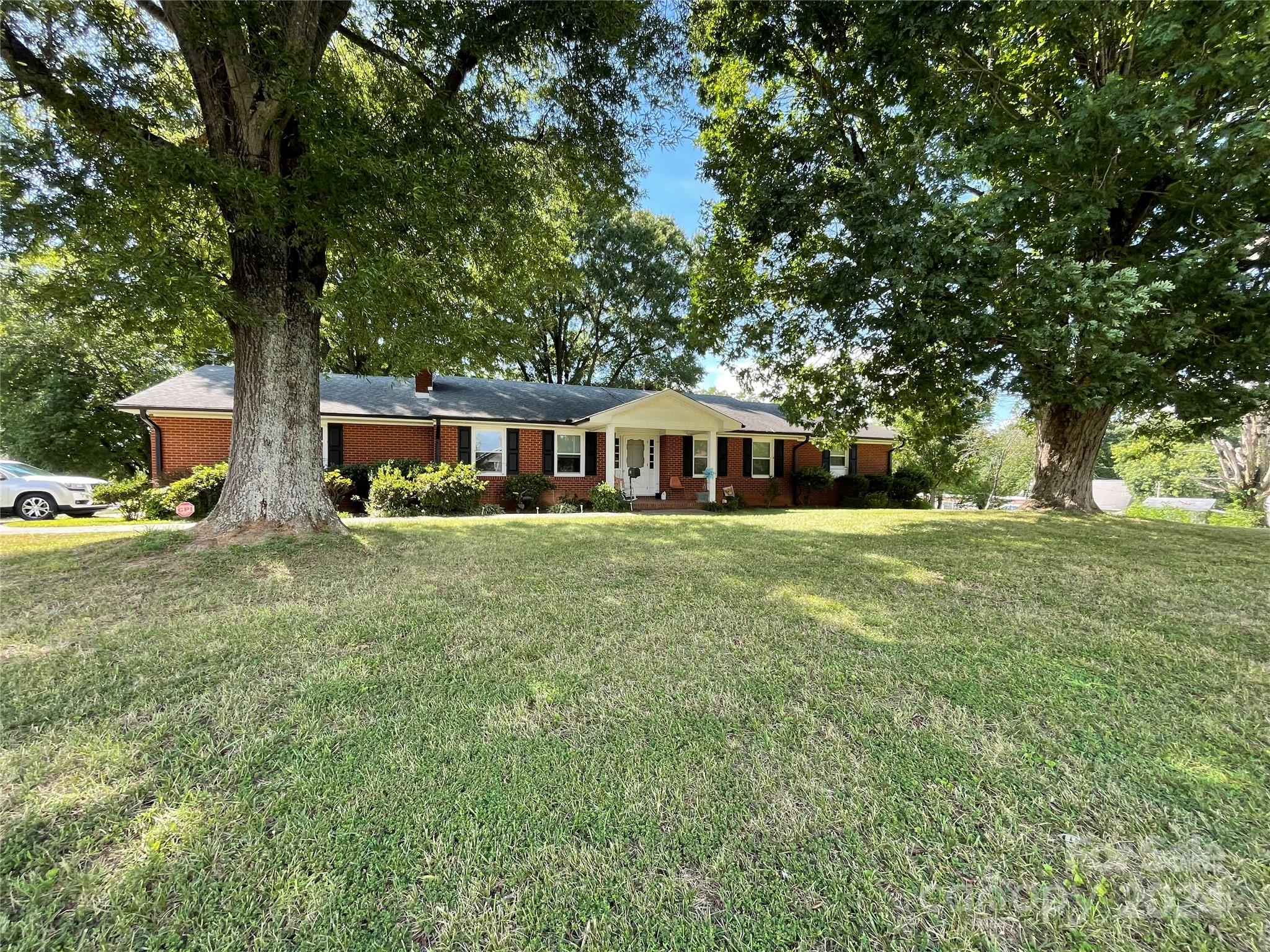 a front view of house with yard and green space