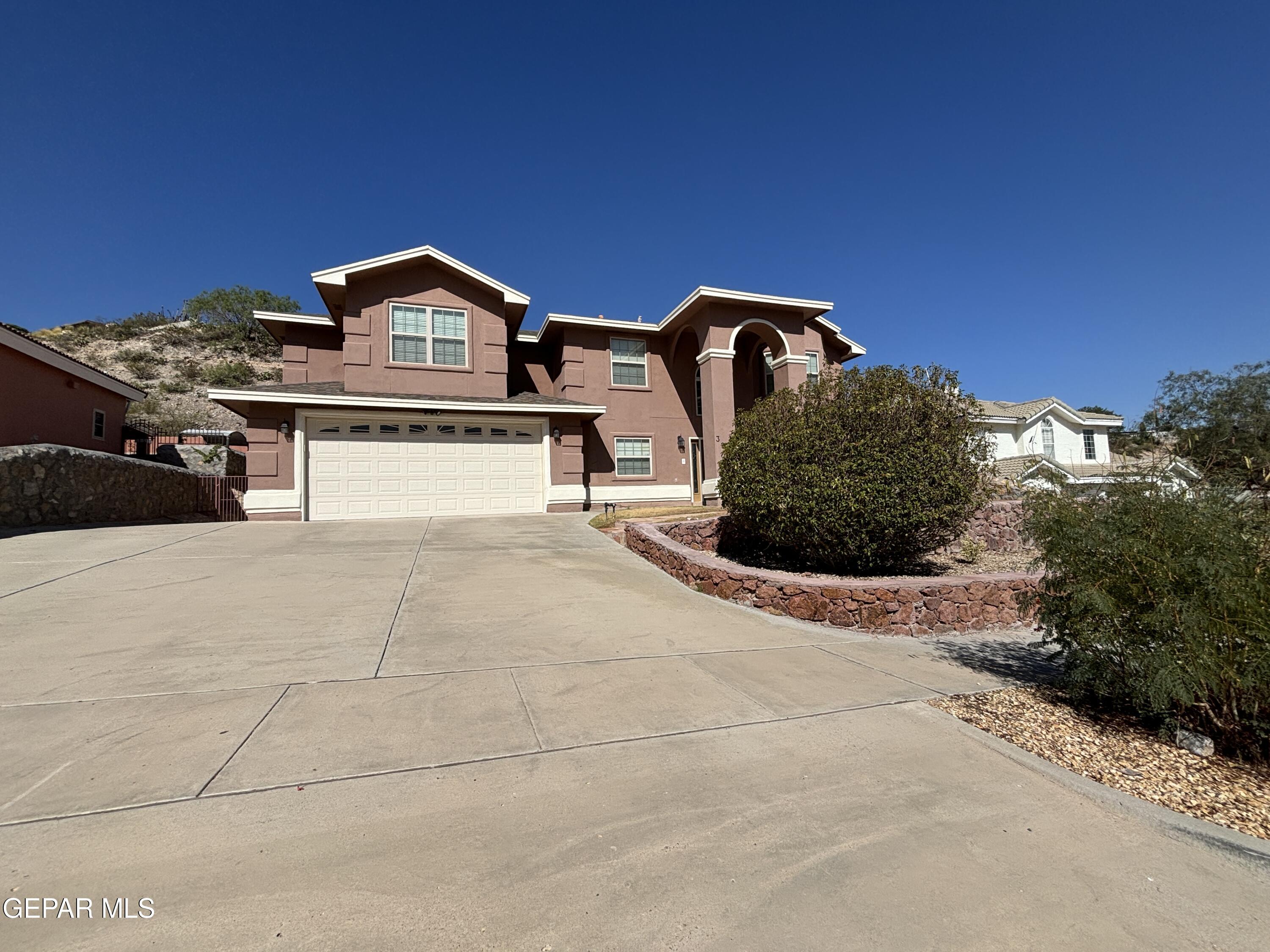 a front view of a house with parking area