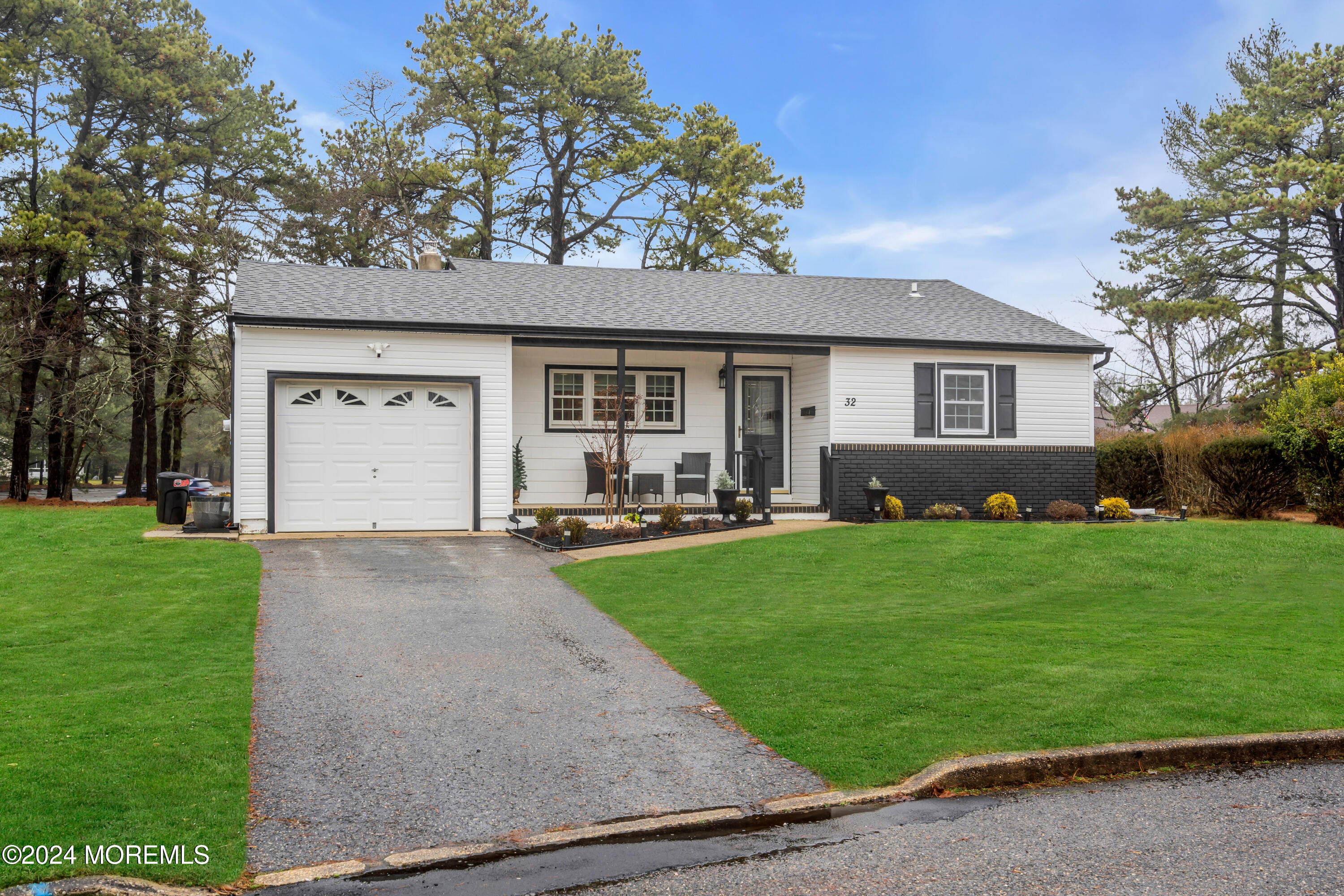 a front view of house with yard and green space