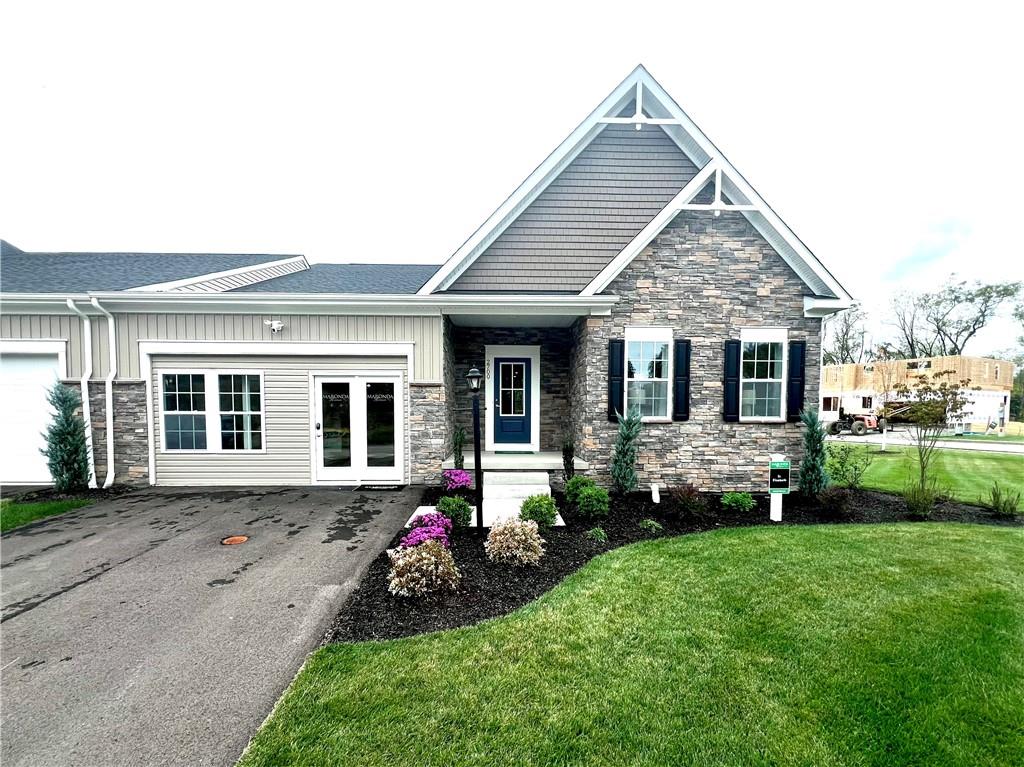 a front view of a house with a garden and porch