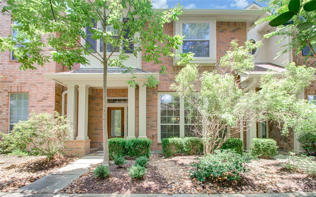 front view of a house with potted plants