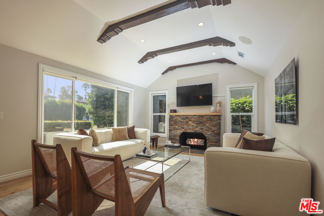 a living room with furniture fireplace and a flat screen tv