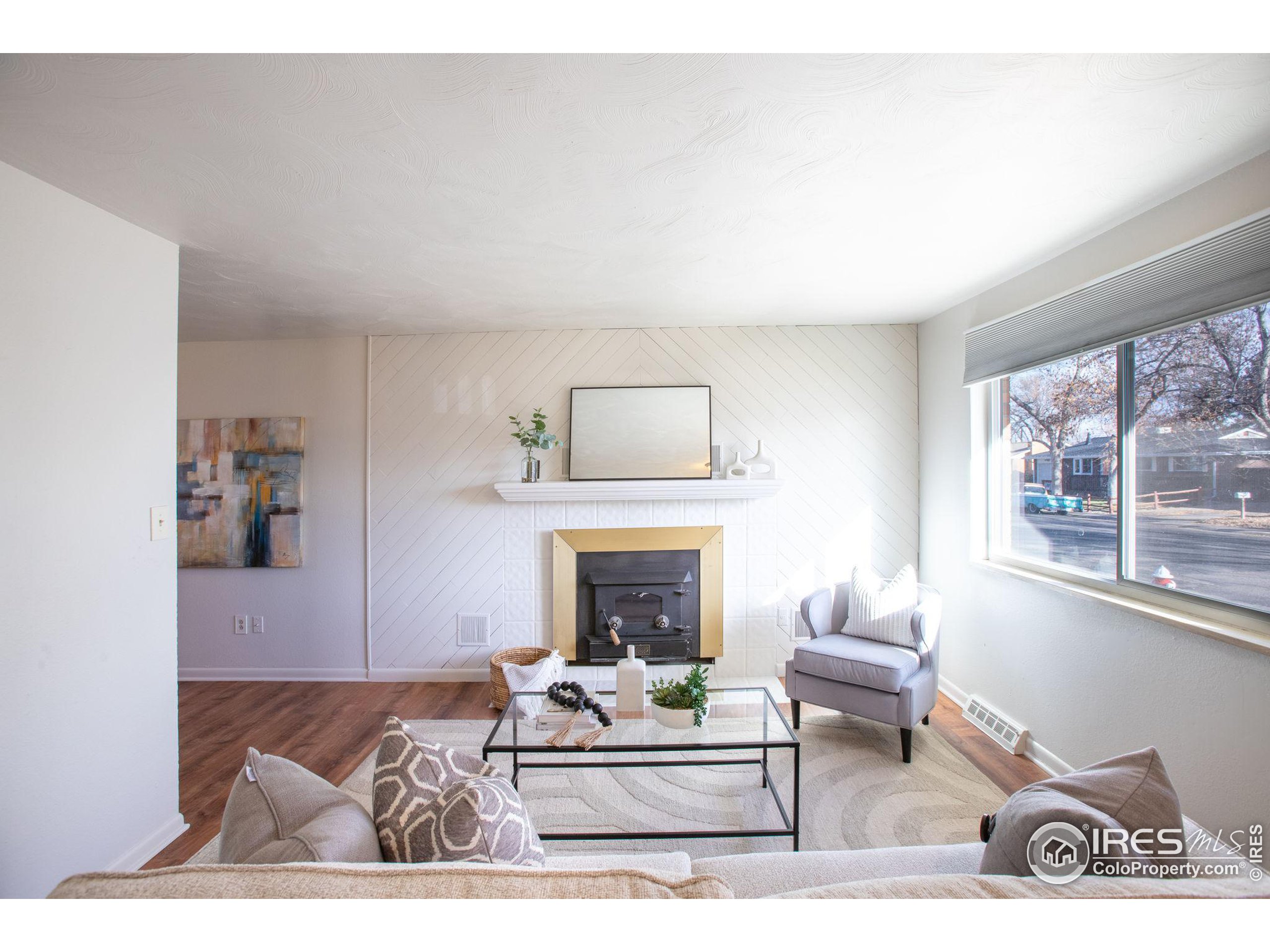 a living room with furniture a window and a fireplace