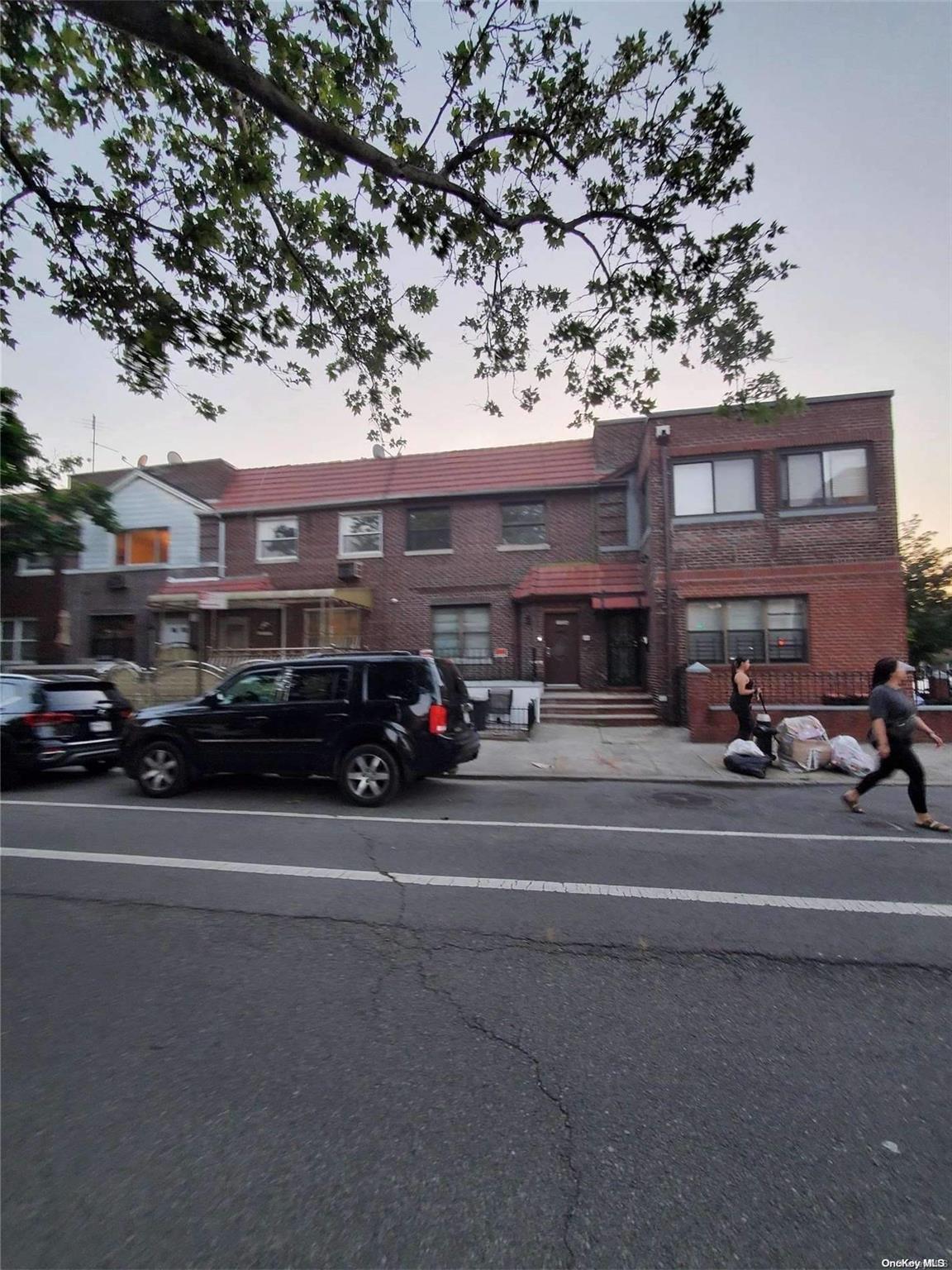 a couple of cars parked in front of a building