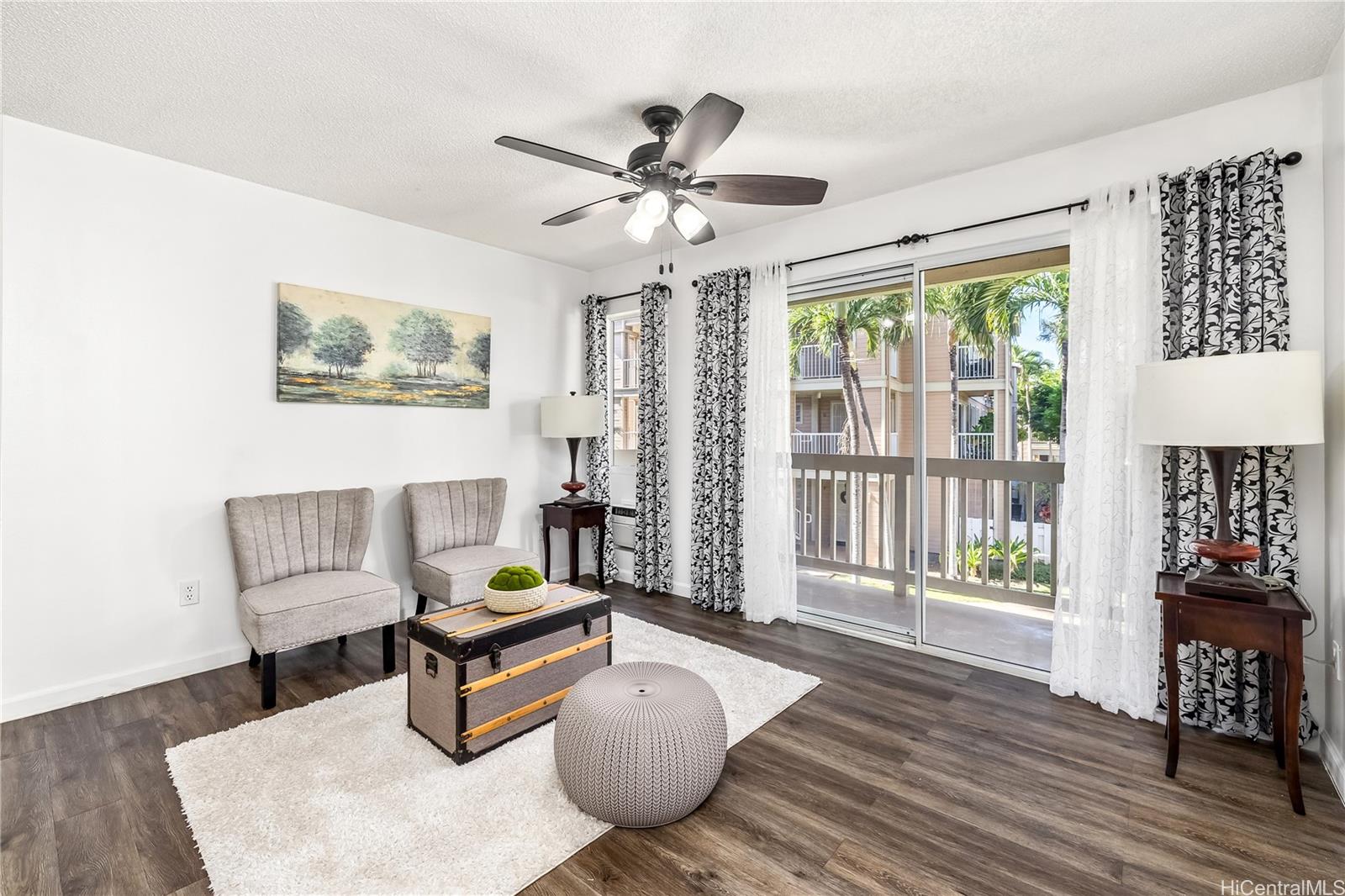 You are welcomed by a fresh breeze and view of the tropical garden as you enter this cozy contemporary open layout living room.