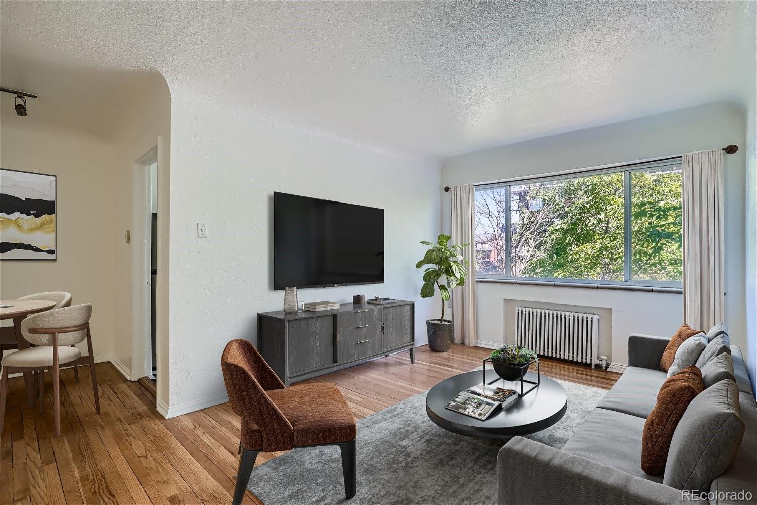 a living room with furniture a fireplace and a flat screen tv