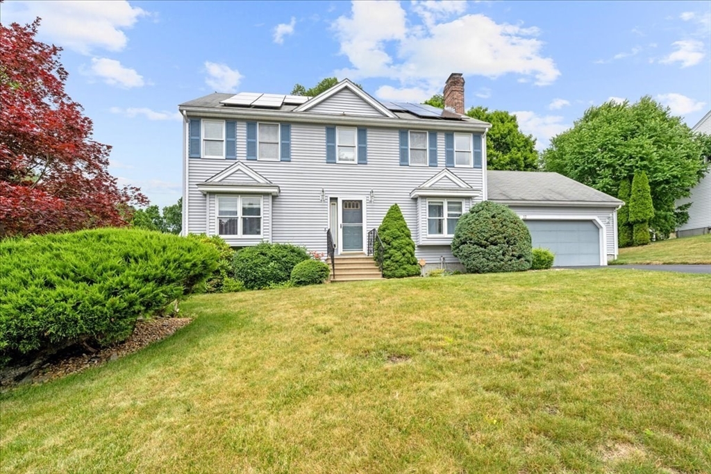 a front view of a house with a garden