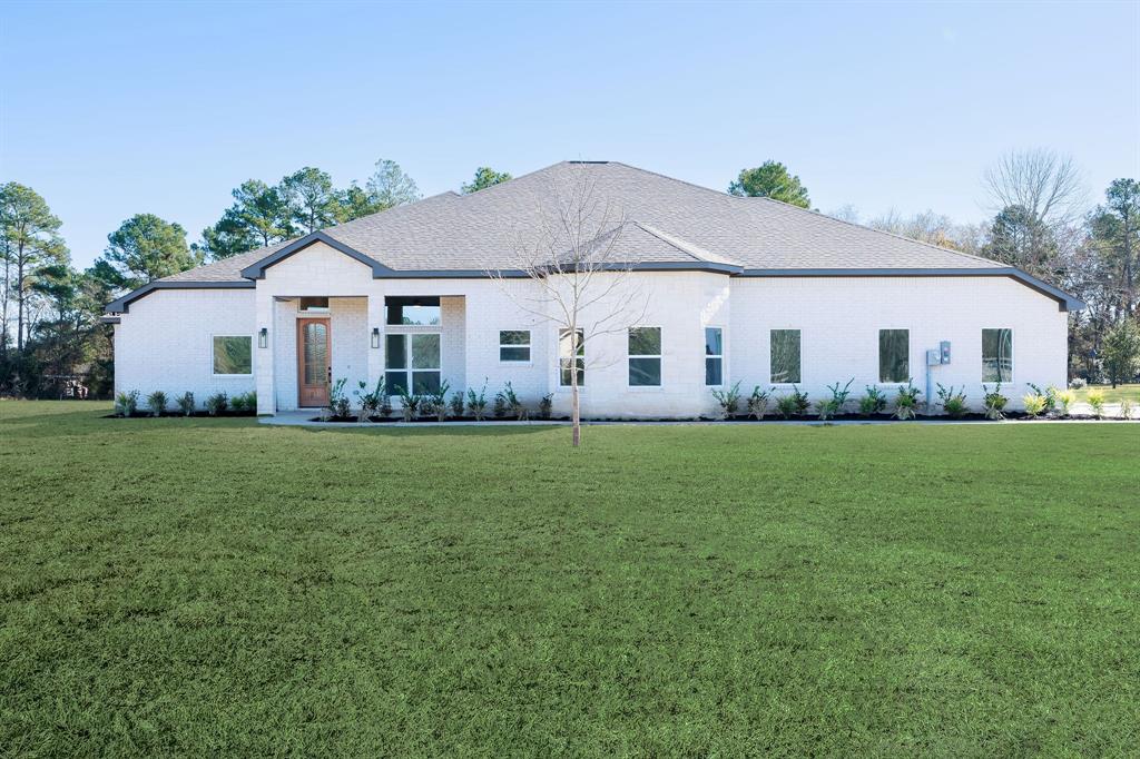 a front view of a house with a garden and porch