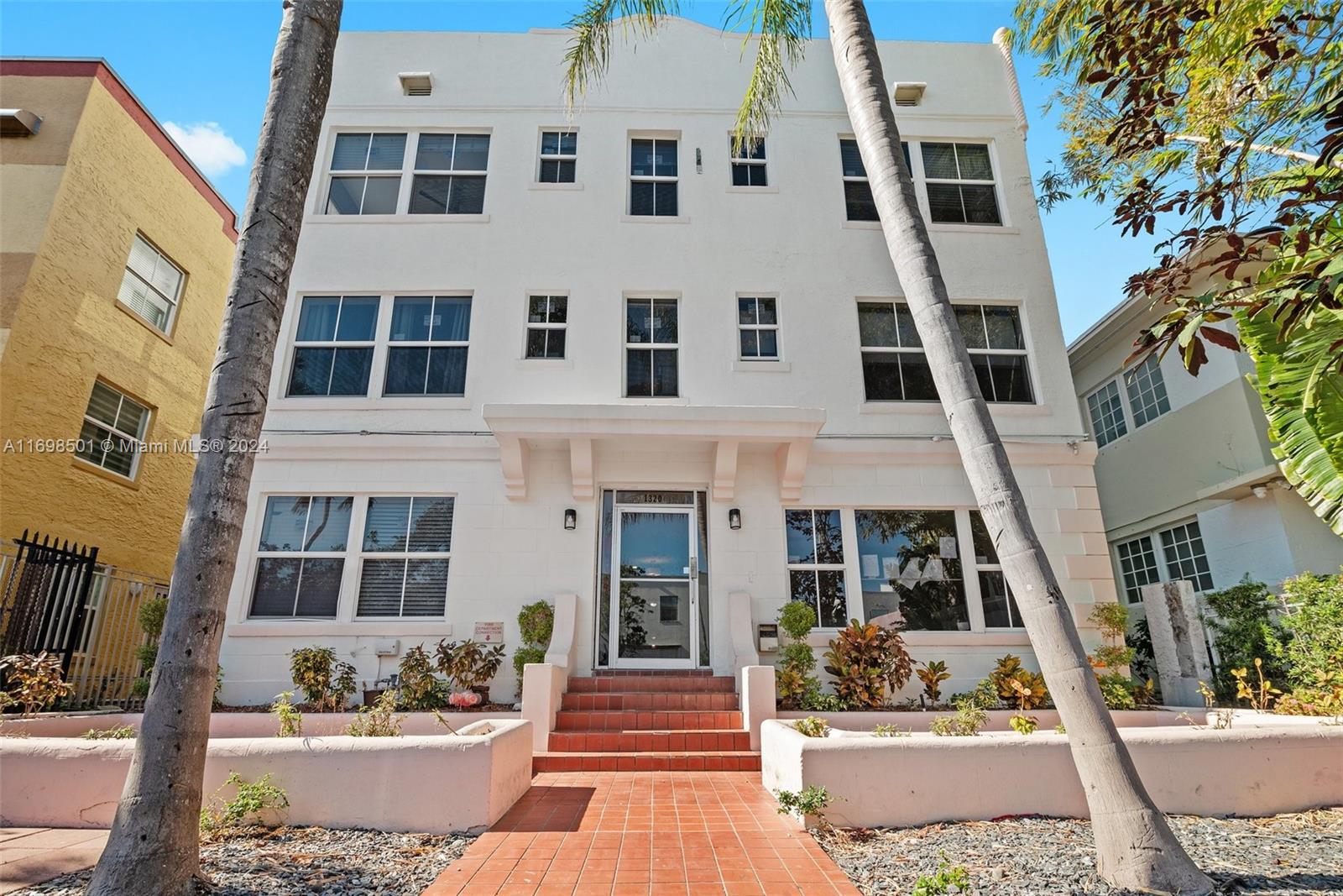 a front view of a building with outdoor seating