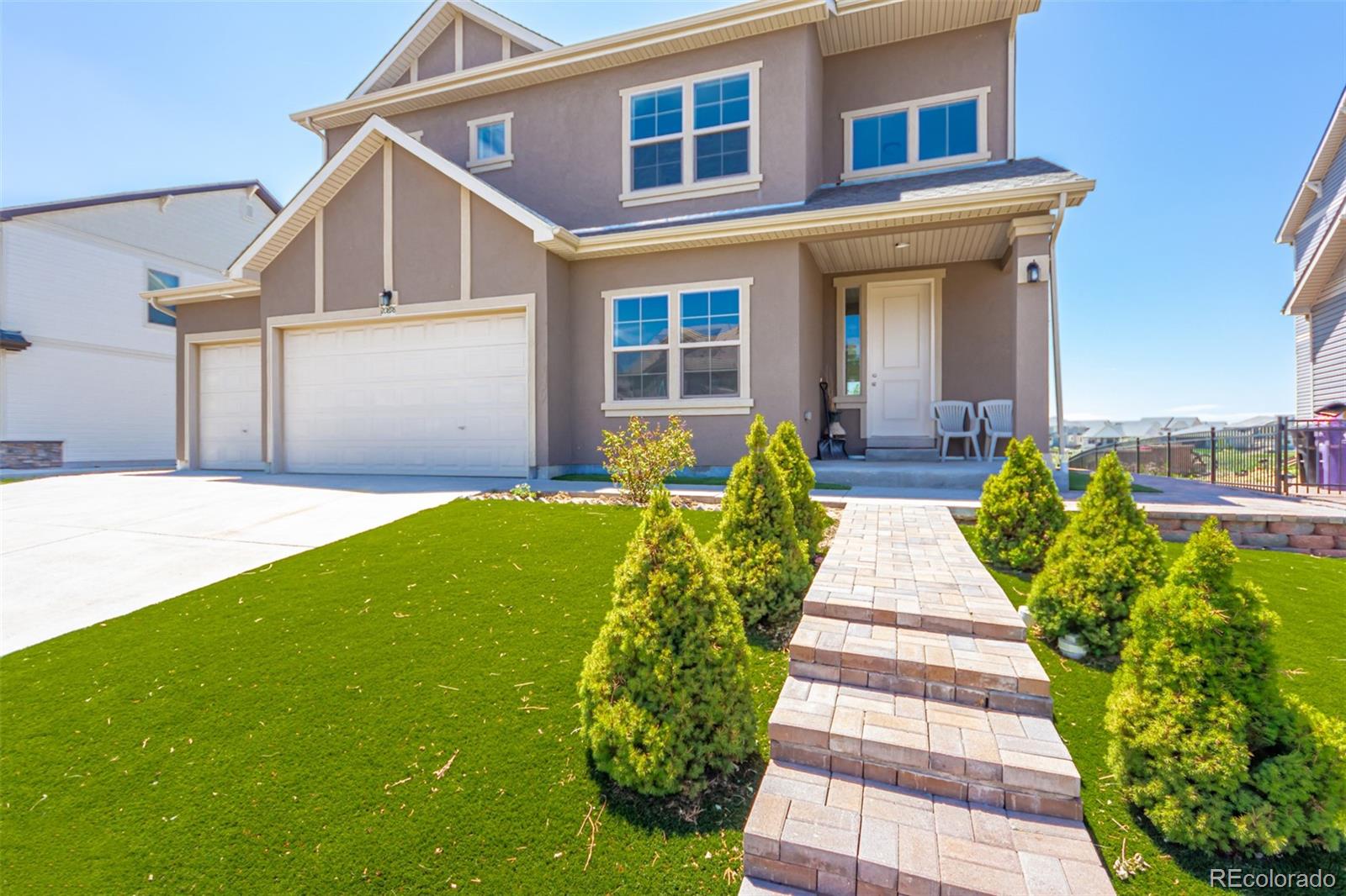 a front view of a house with a yard