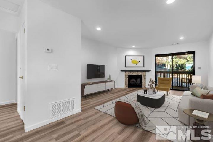 a living room with furniture a fireplace and a flat screen tv