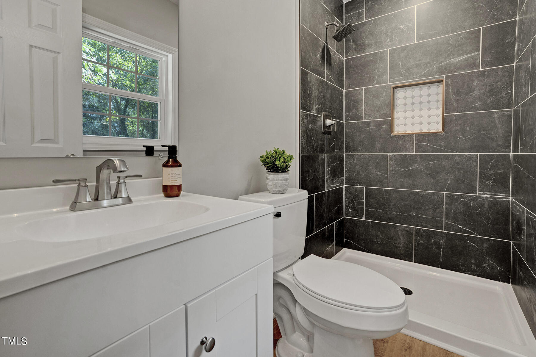 a bathroom with a sink a toilet and a mirror