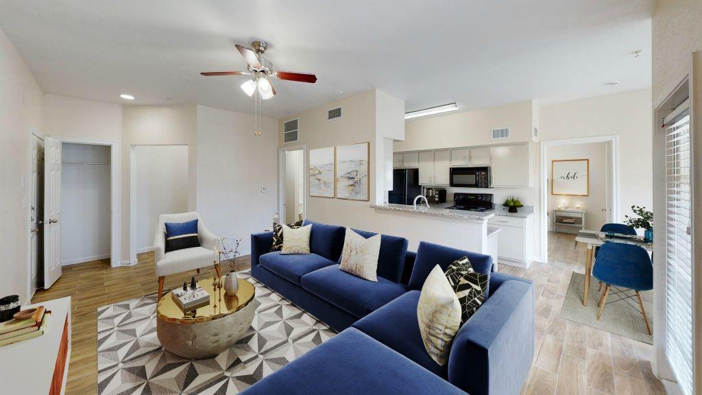 a living room with furniture and kitchen view