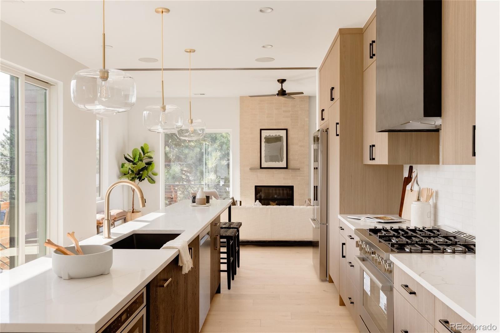 a kitchen with stainless steel appliances a sink a stove and a refrigerator