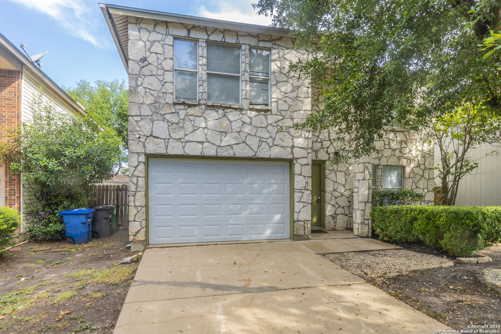 a front view of a house with garage