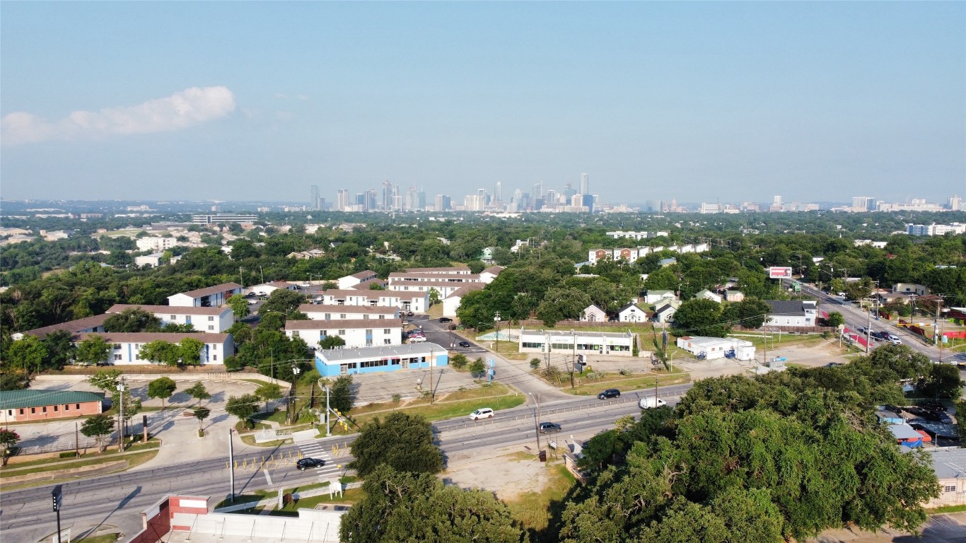 an aerial view of residential houses with city view