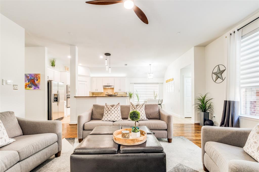 a living room with furniture kitchen view and a window