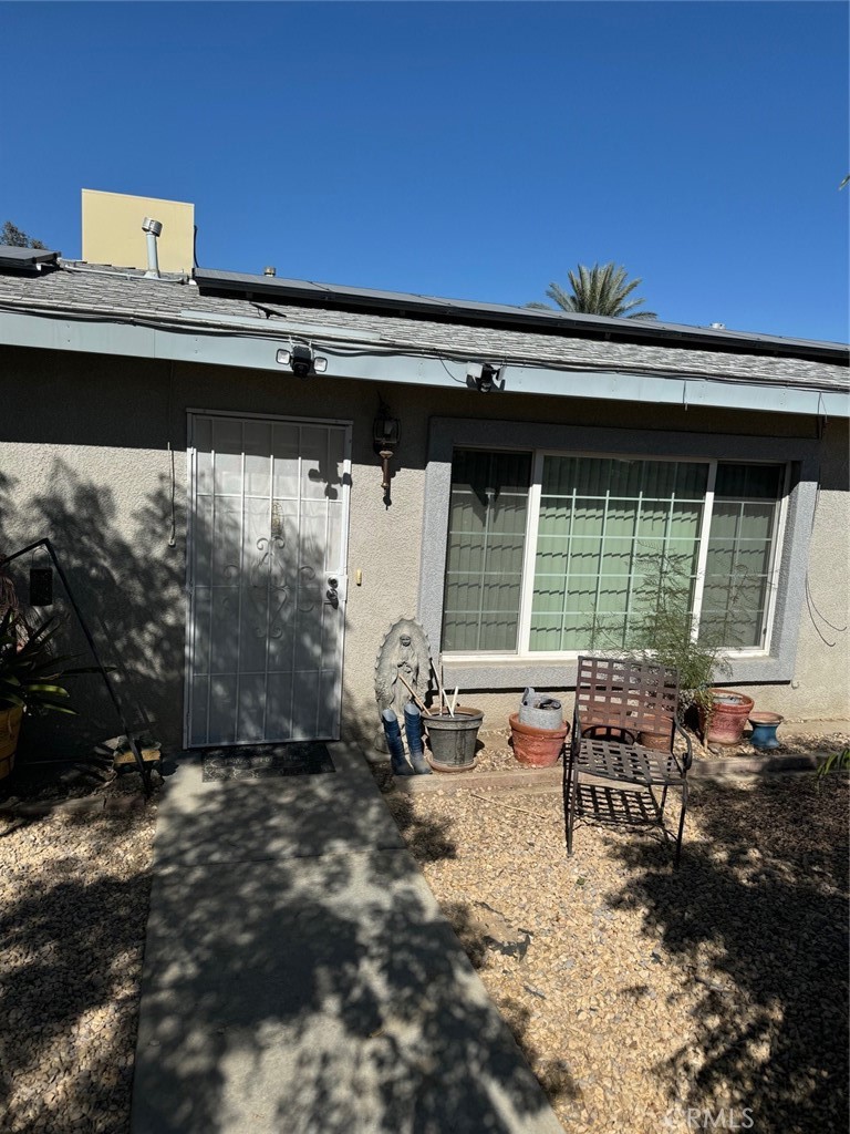 a backyard of a house with table and chairs