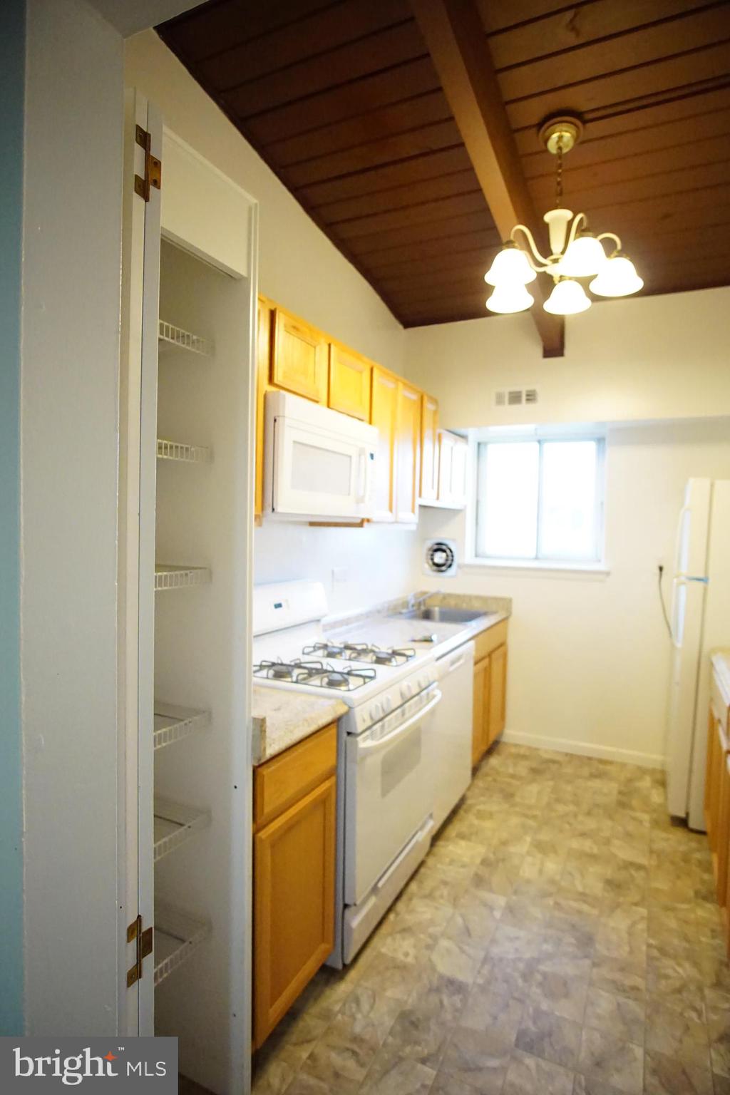 a kitchen with a stove a sink and a refrigerator