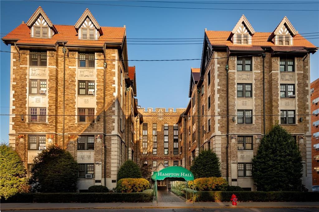 a front view of a residential apartment building with a yard