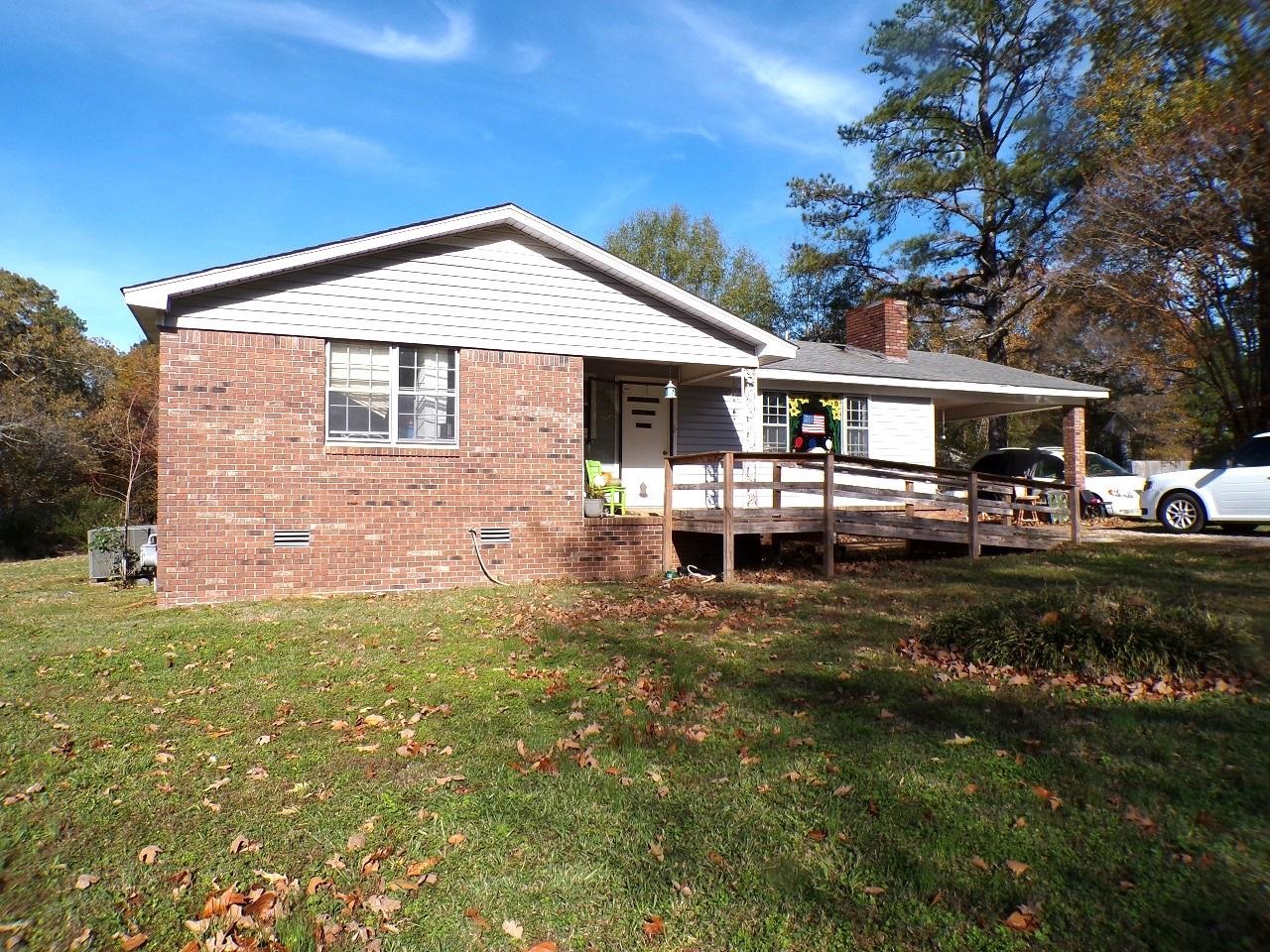 a front view of a house with a yard table and chairs