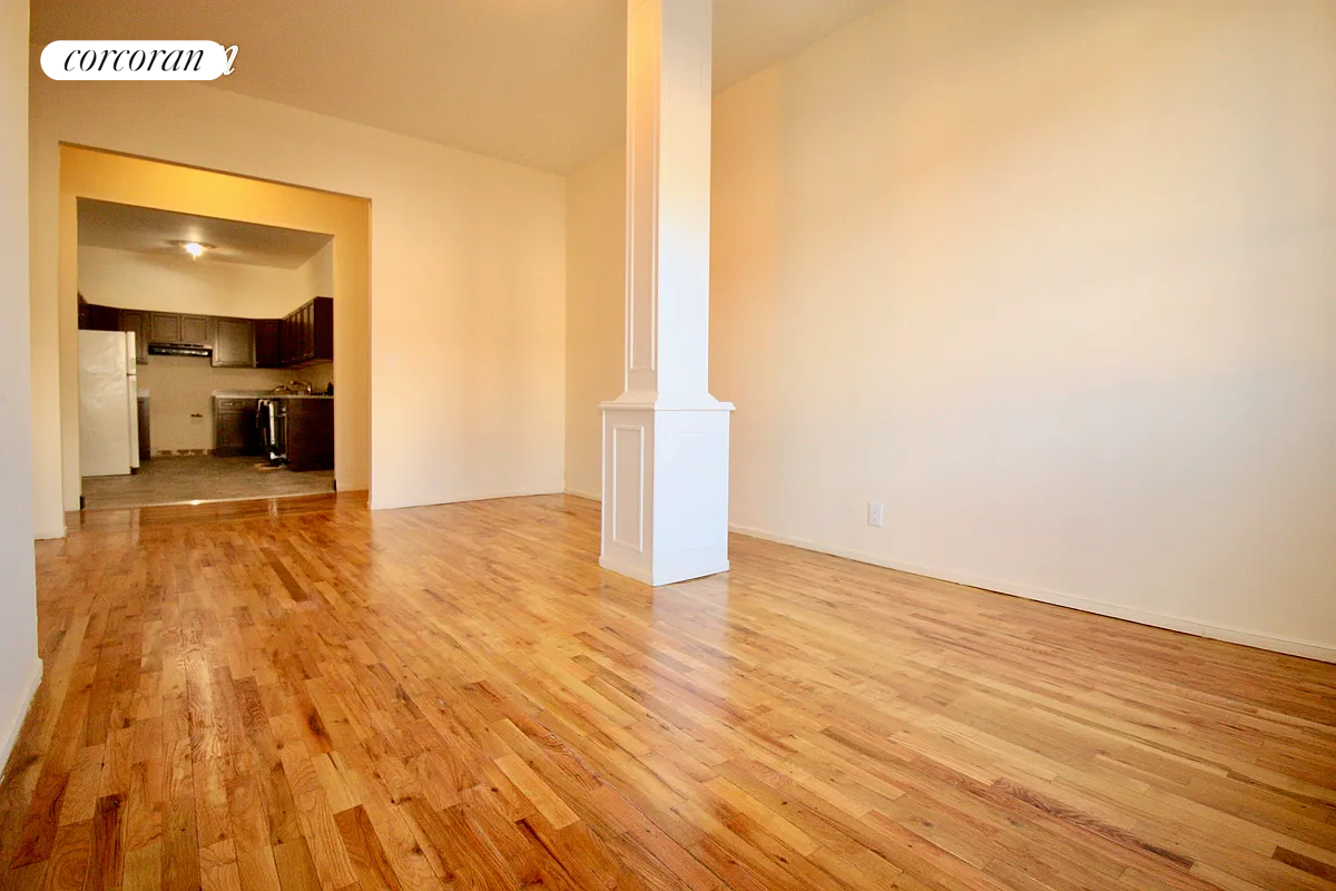 a view of a livingroom with wooden floor and a staircase